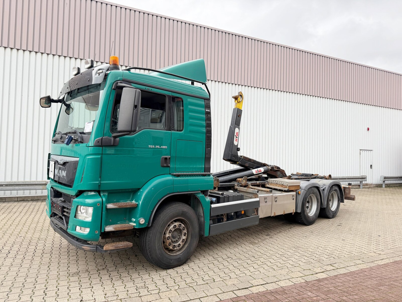 MAN TGS 26.480 6x4 BL TGS 26.480 6x4 BL, Motorabtrieb, Navi, Intarder, Hyva 20.60 S - Hook lift truck: picture 1 MAN TGS 26.480 6x4 BL TGS 26.480 6x4 BL, Motorabtrieb, Navi, Intarder, Hyva 20.60 S - Hook lift truck: picture 1